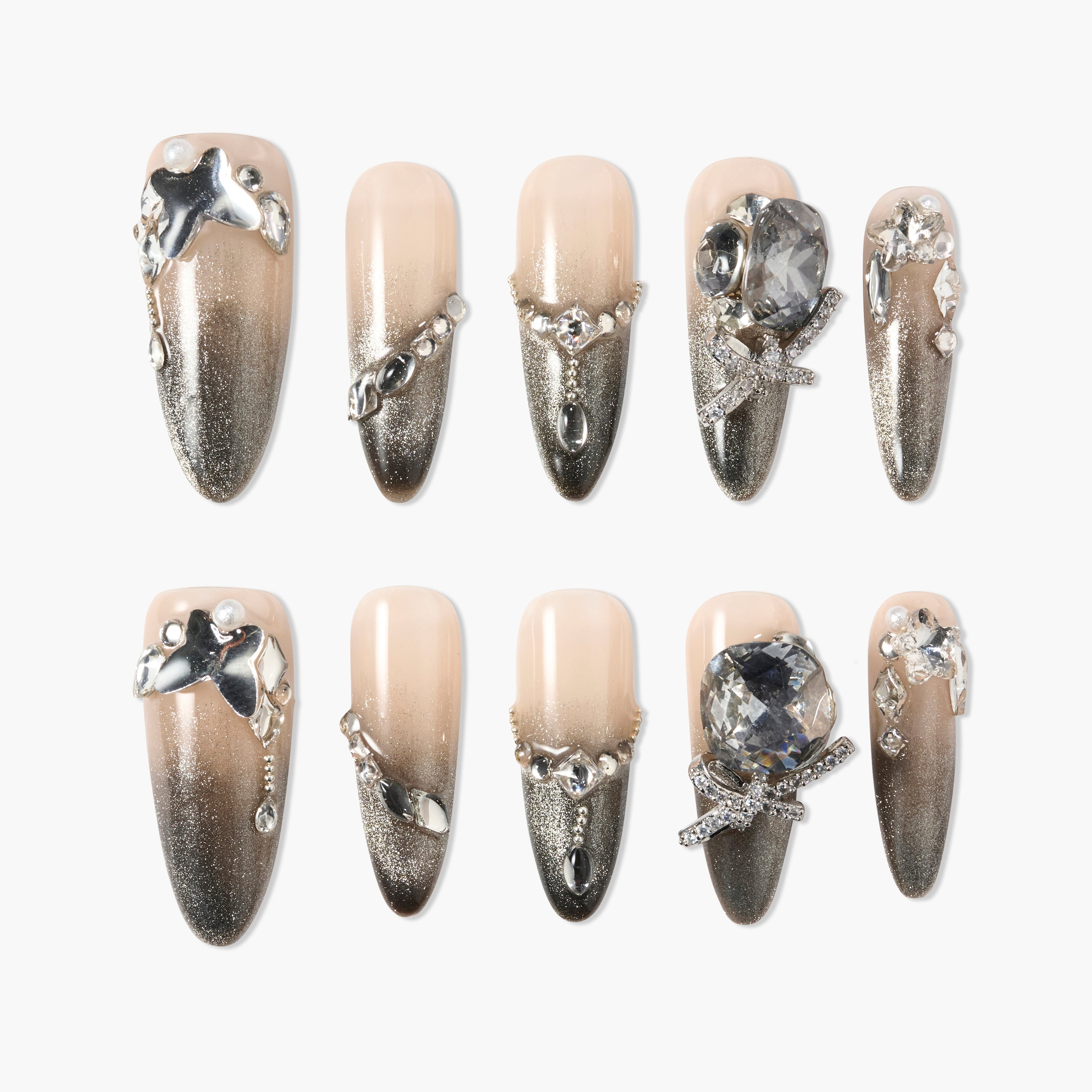 Handmade press-on nails with nude to silver ombre, rhinestones, and 3D metallic accents