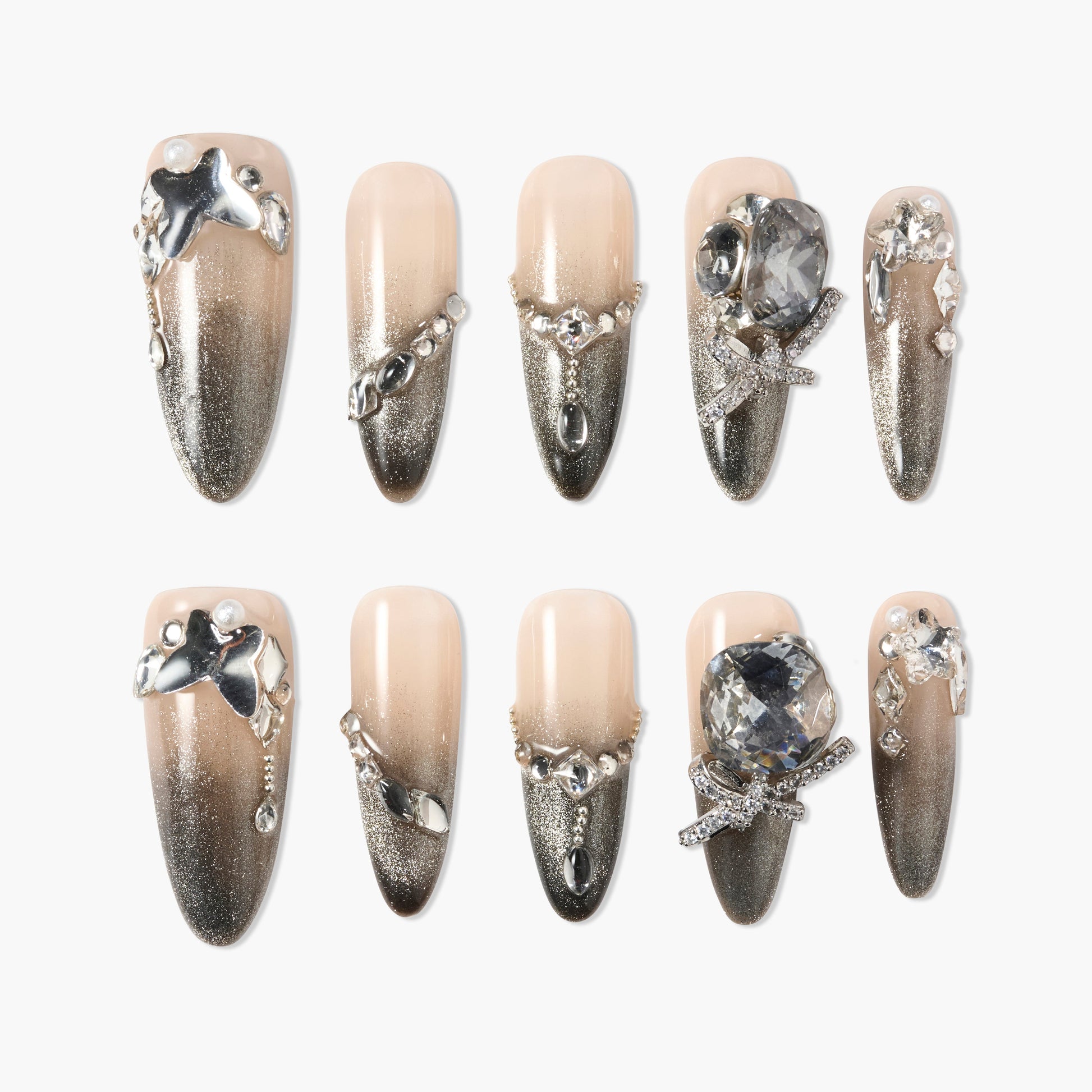Handmade press-on nails with nude to silver ombre, rhinestones, and 3D metallic accents