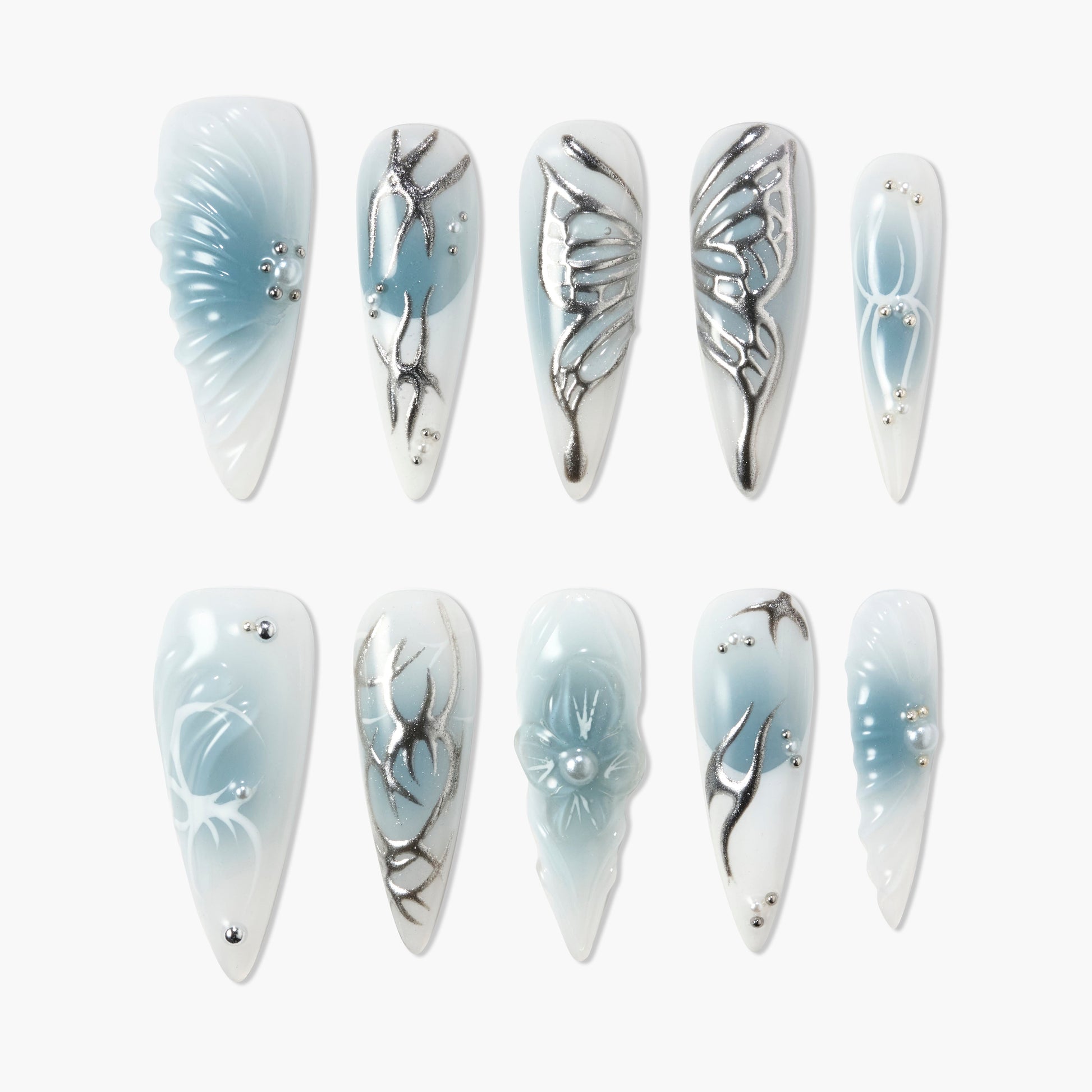 Blue and white press-on nails with silver accents, butterfly and floral designs