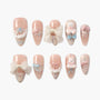 Cute handmade press-on nails in soft pink with bows, lace, 3D bear and bunny accents.