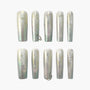 Iridescent coffin-shaped press-on nails with white marble and two accent rings
