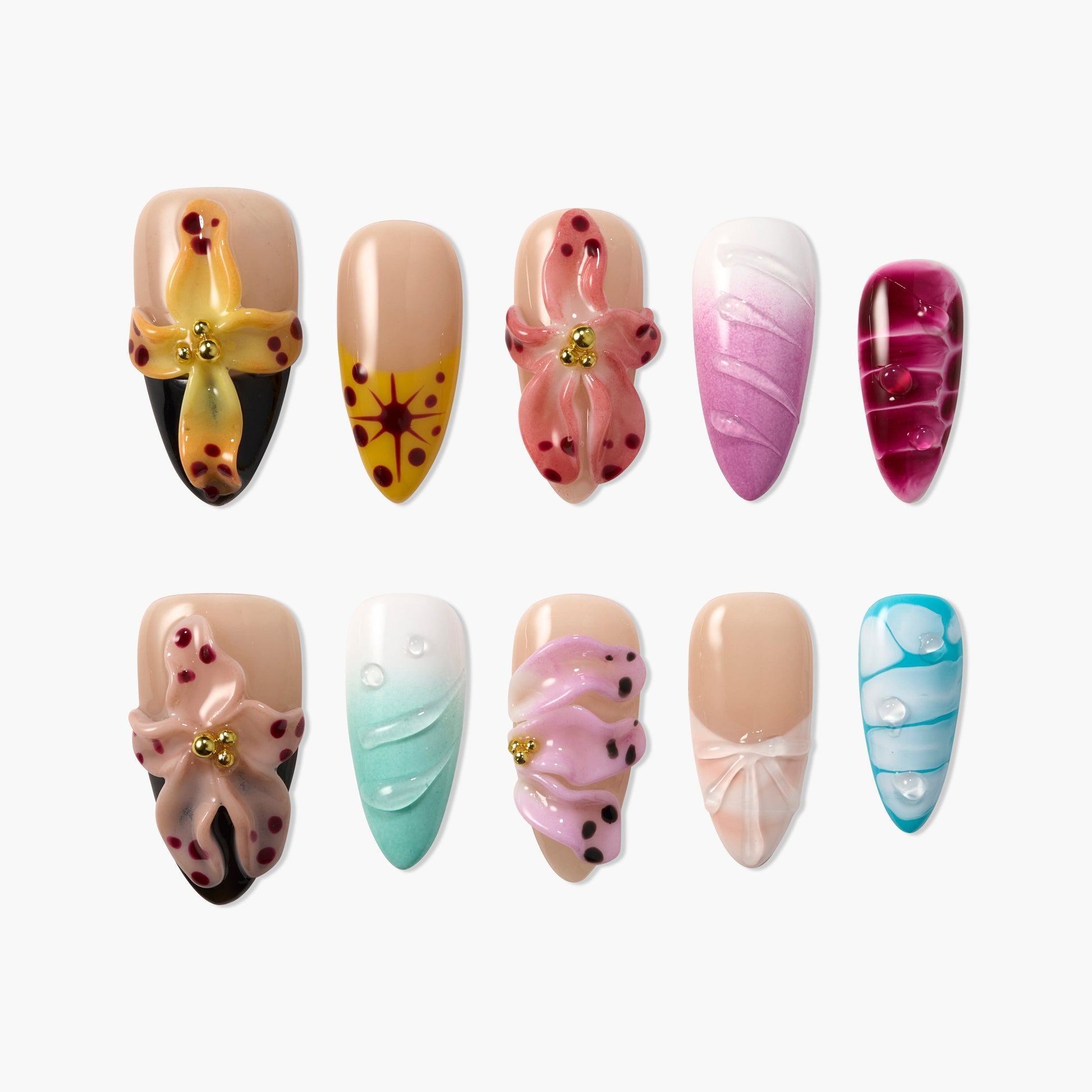 Handmade press-on nails with 3D floral and abstract designs in various colors, arranged on white background.