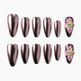 Glossy metallic rose gold press-on nails with 3D pink and yellow floral accents and rhinestones