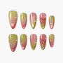 Green and pink ombre press-on nails with pearl accents and 3D bow designs, arranged on white background