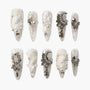 Handmade press-on nails with white and silver 3D floral, pearl, angel, and moon designs