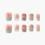 Handmade press-on nails with pink and blue bow designs and pastel gradient tips