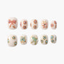 Handmade press-on nails with pastel bow and flower designs, pearl and gem accents on white base