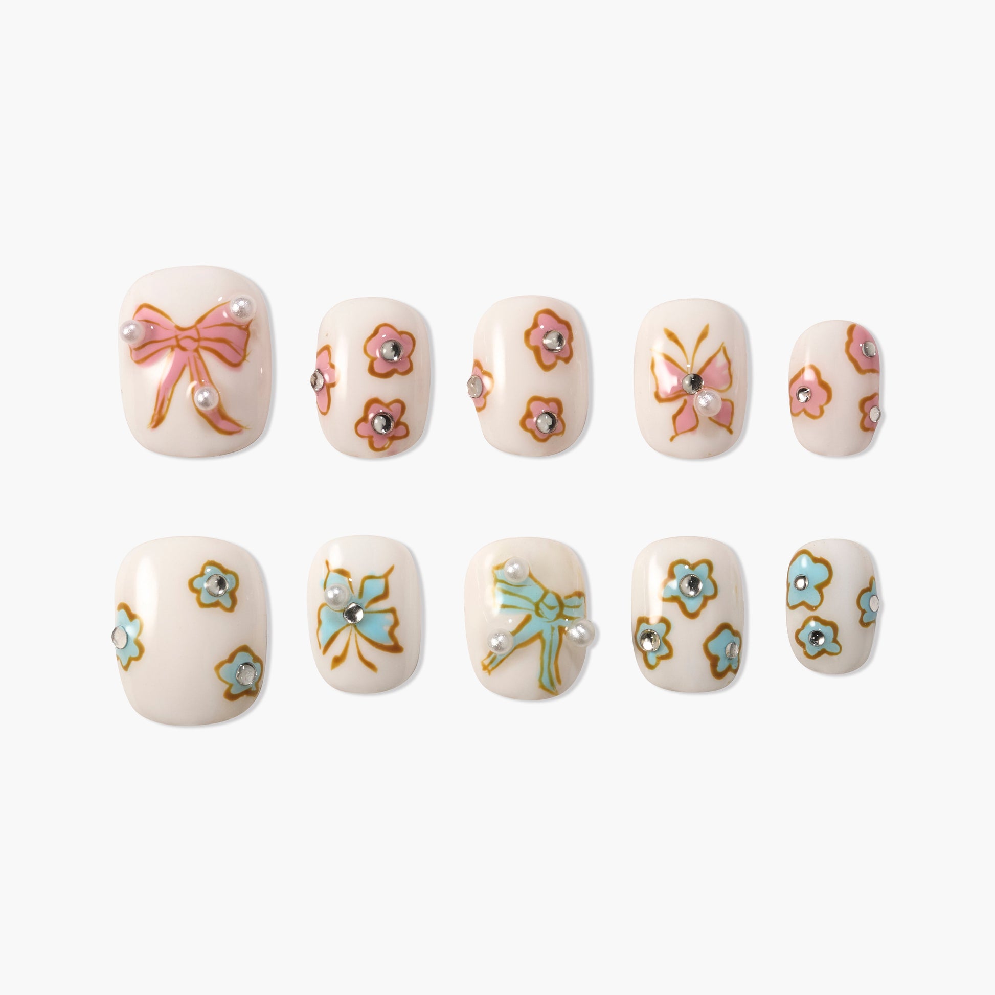 Handmade press-on nails with pastel bow and flower designs, pearl and gem accents on white base