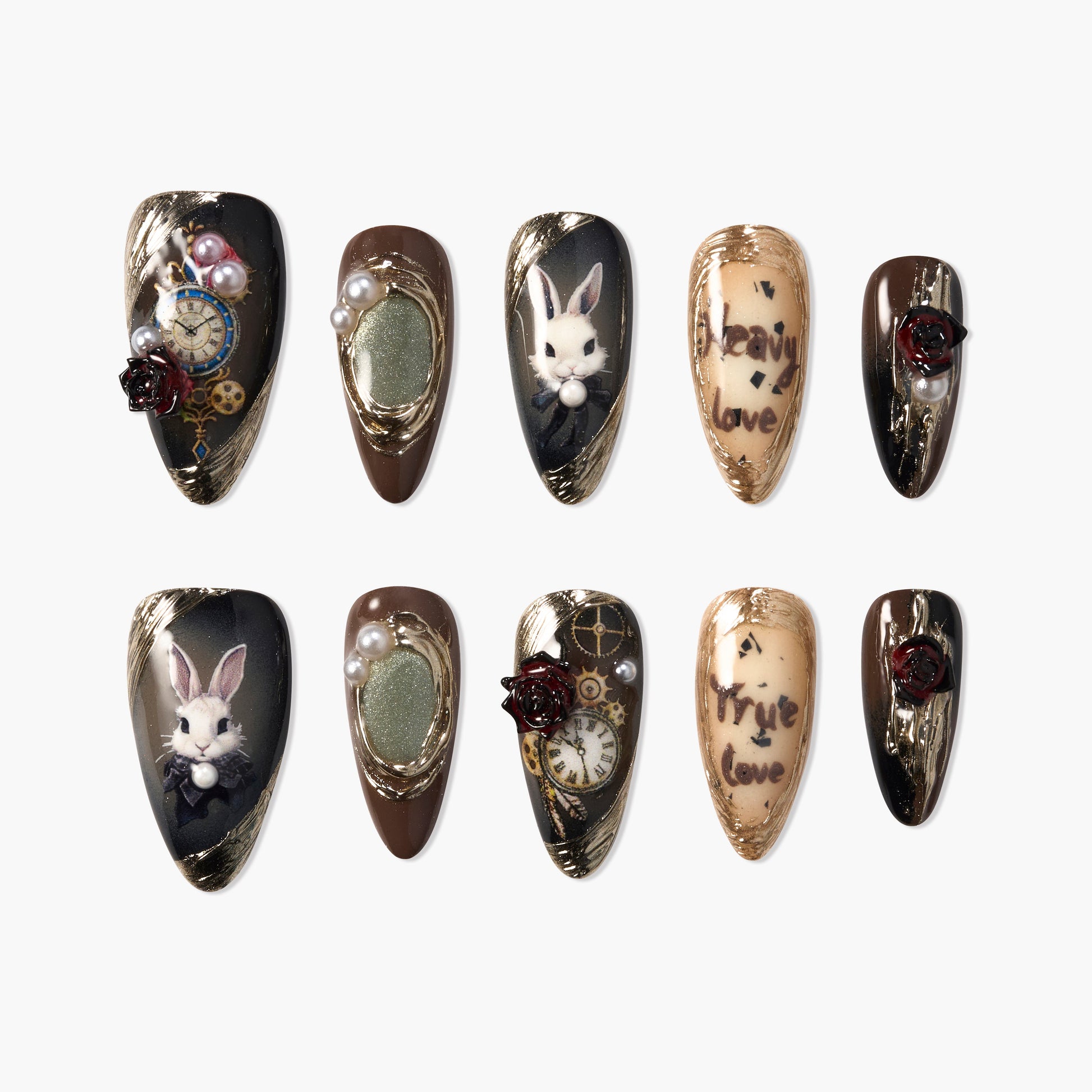 Handmade press-on nails with rabbit art, gold gears, pearls, rose accents, and script designs