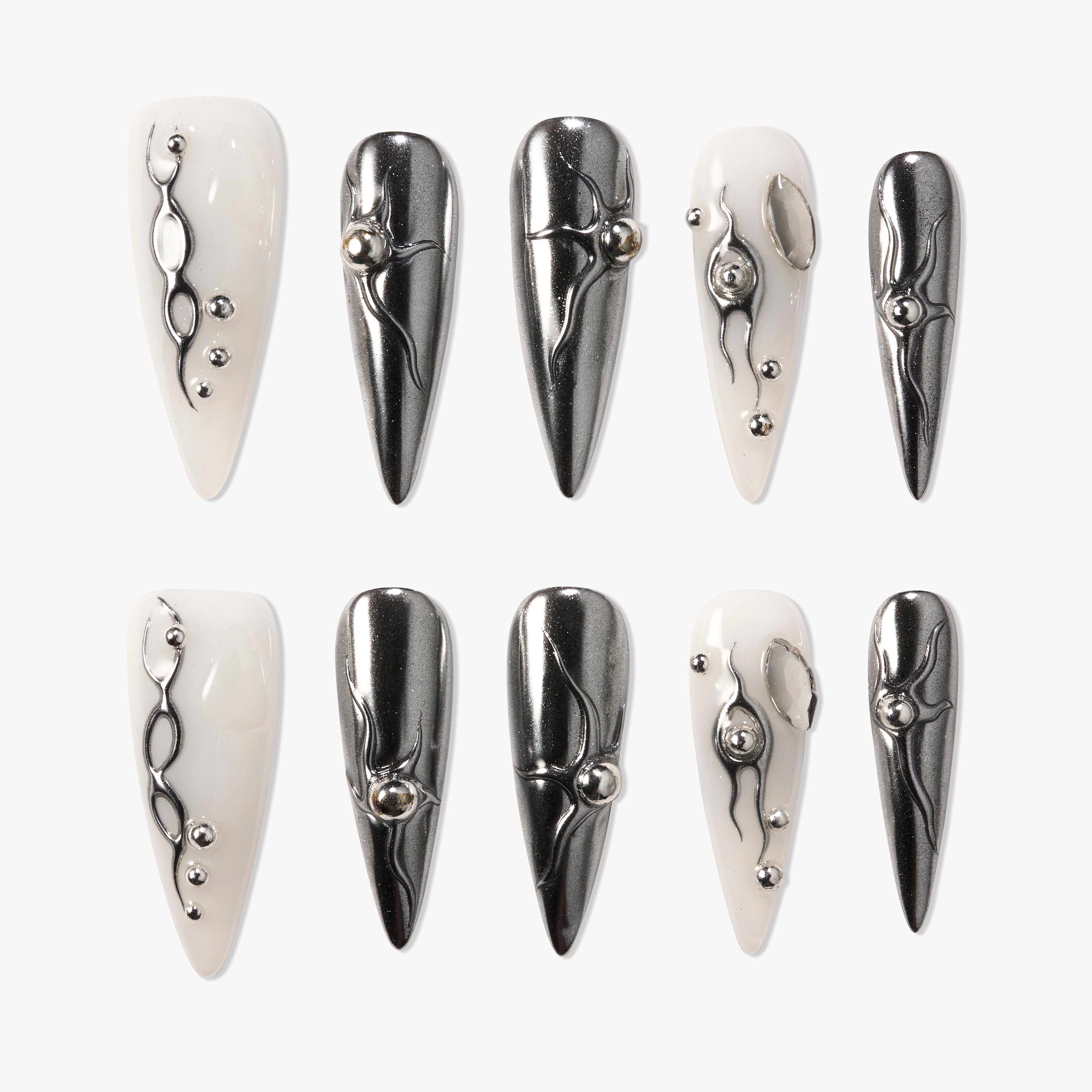 Long stiletto press-on nails in glossy white and metallic silver with 3D abstract accents