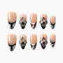 Handmade press-on nails with nude base, black and white tips, and 3D floral accents