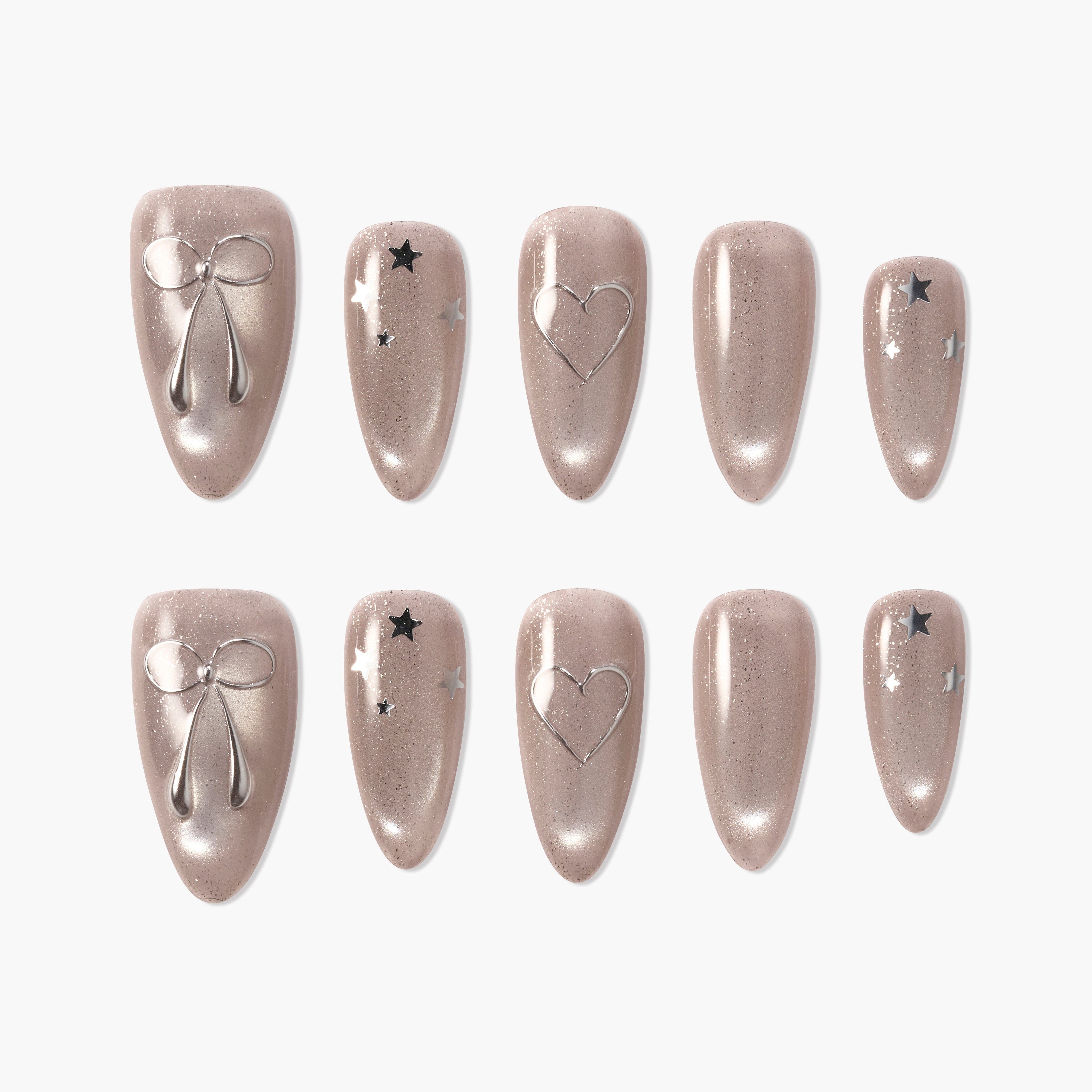 Handmade nude press-on nails with silver bow, heart, and star accents, glossy finish
