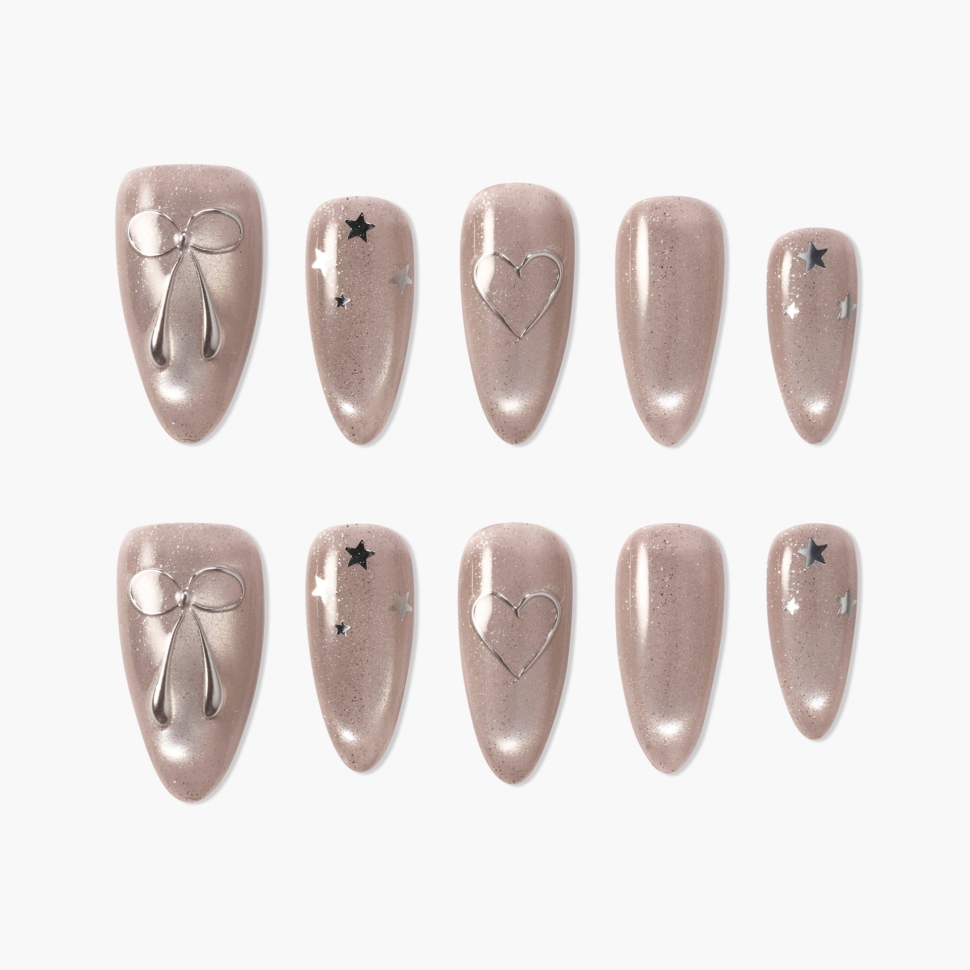 Handmade nude press-on nails with silver bow, heart, and star accents, glossy finish