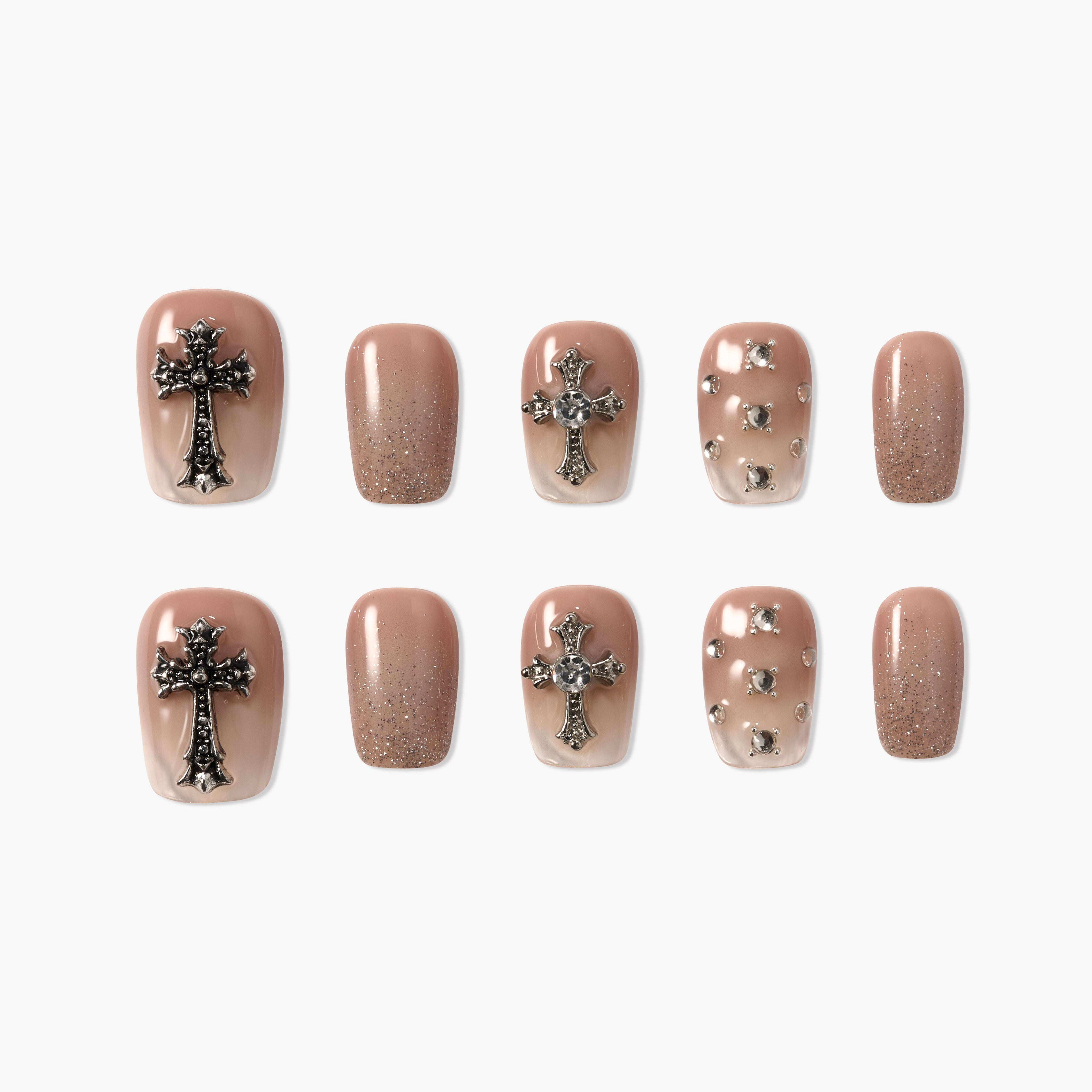 Handmade press-on nails in nude gradient with cross and rhinestone accents, glitter finish