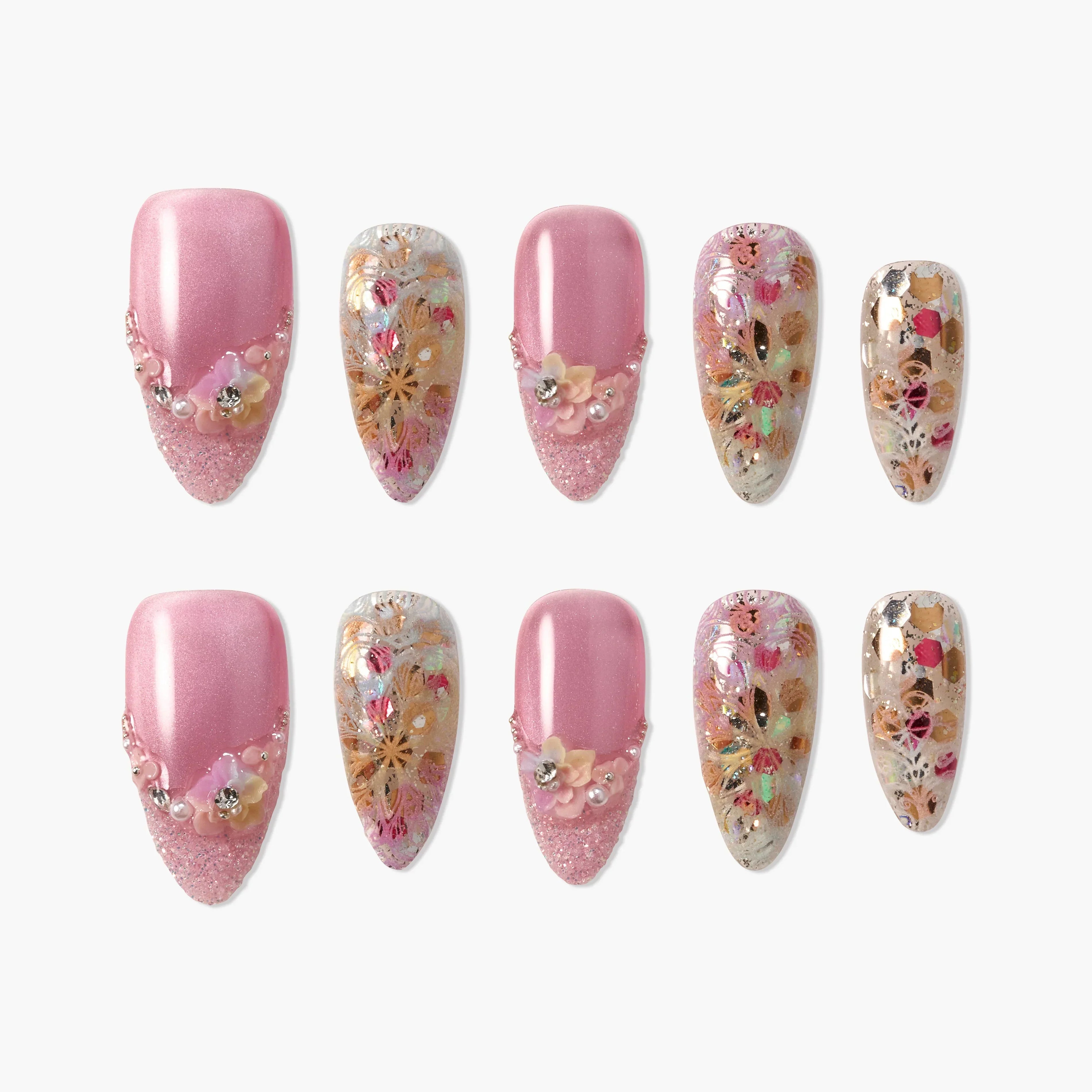 Handmade press-on nails with pink glitter, 3D floral accents, and gold floral designs.