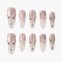 Handmade press-on nails with pink and clear ombre, 3D floral art, rhinestones, and pearls