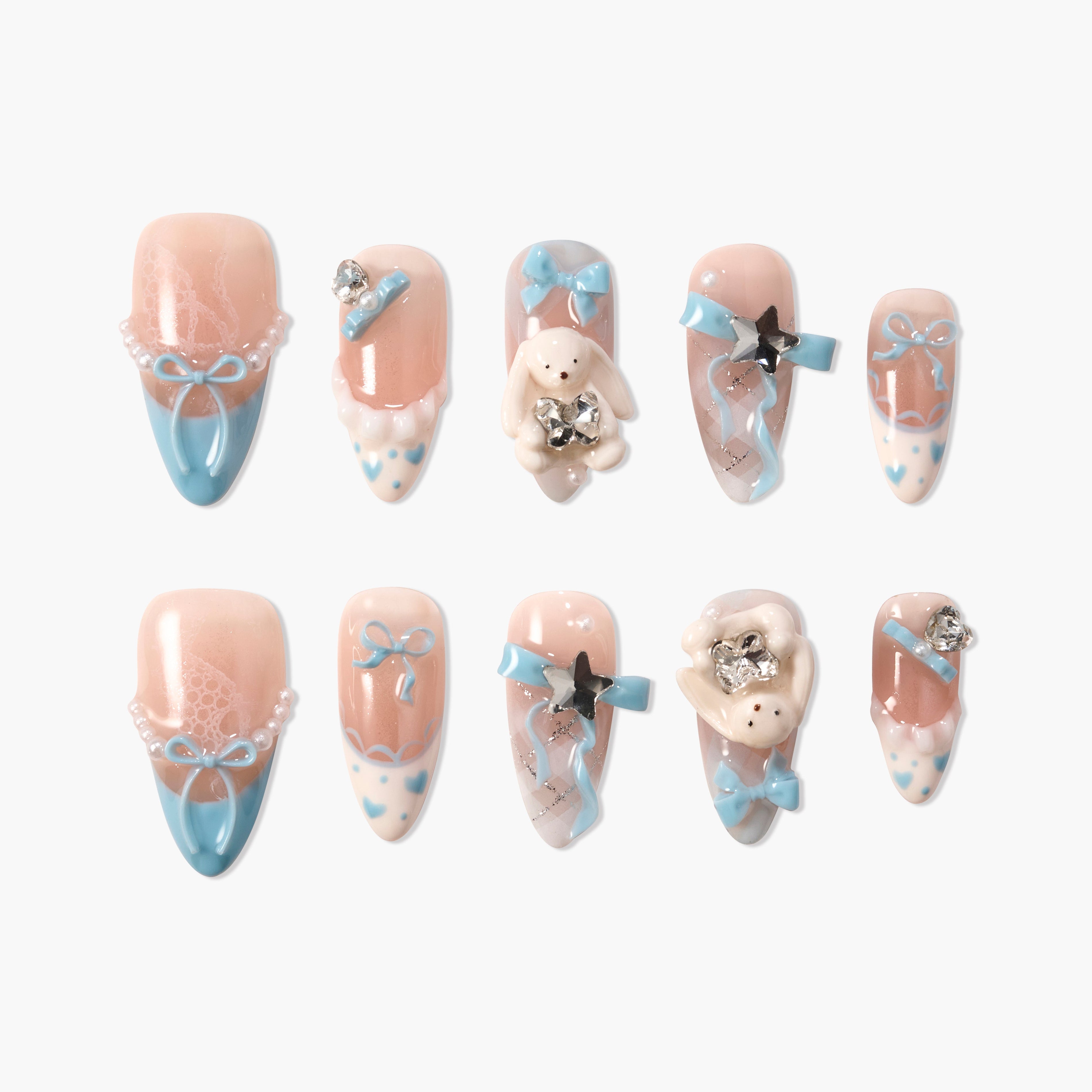 Handmade press-on nails with pastel pink and blue designs, bows, pearls, bunny charms, and rhinestones.