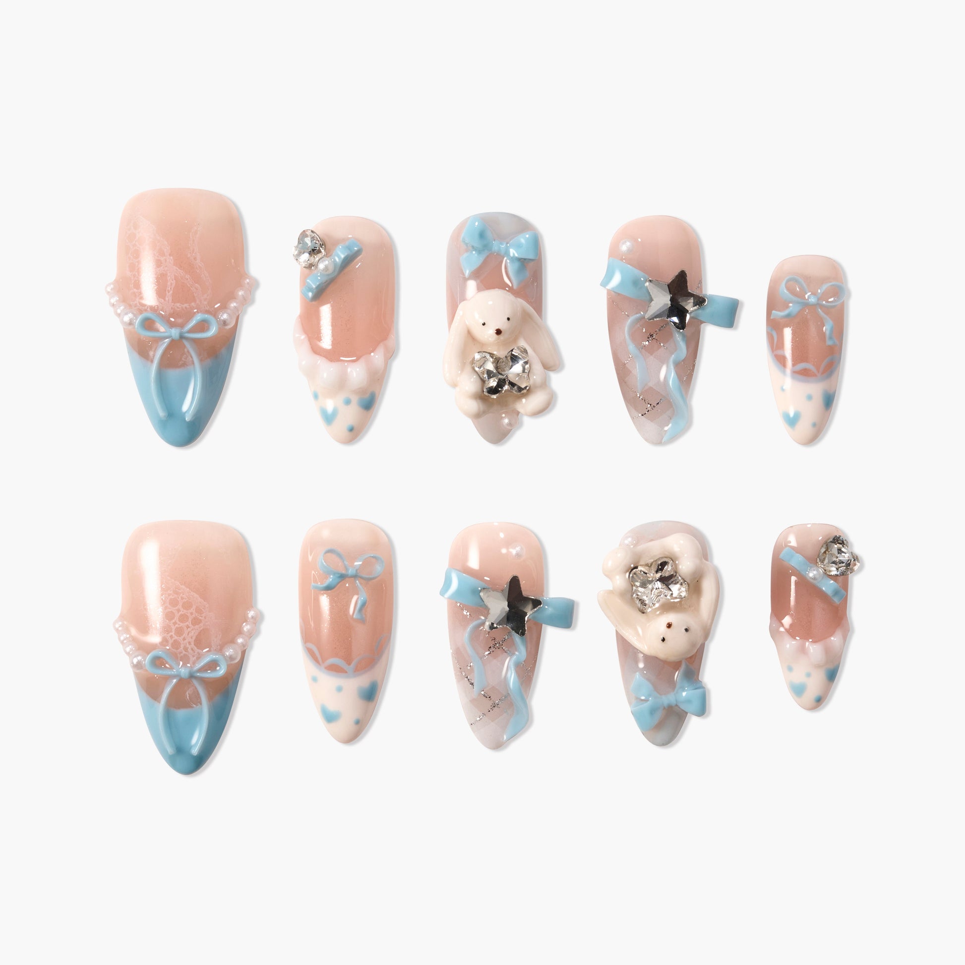 Handmade press-on nails with pastel pink and blue designs, bows, pearls, bunny charms, and rhinestones.