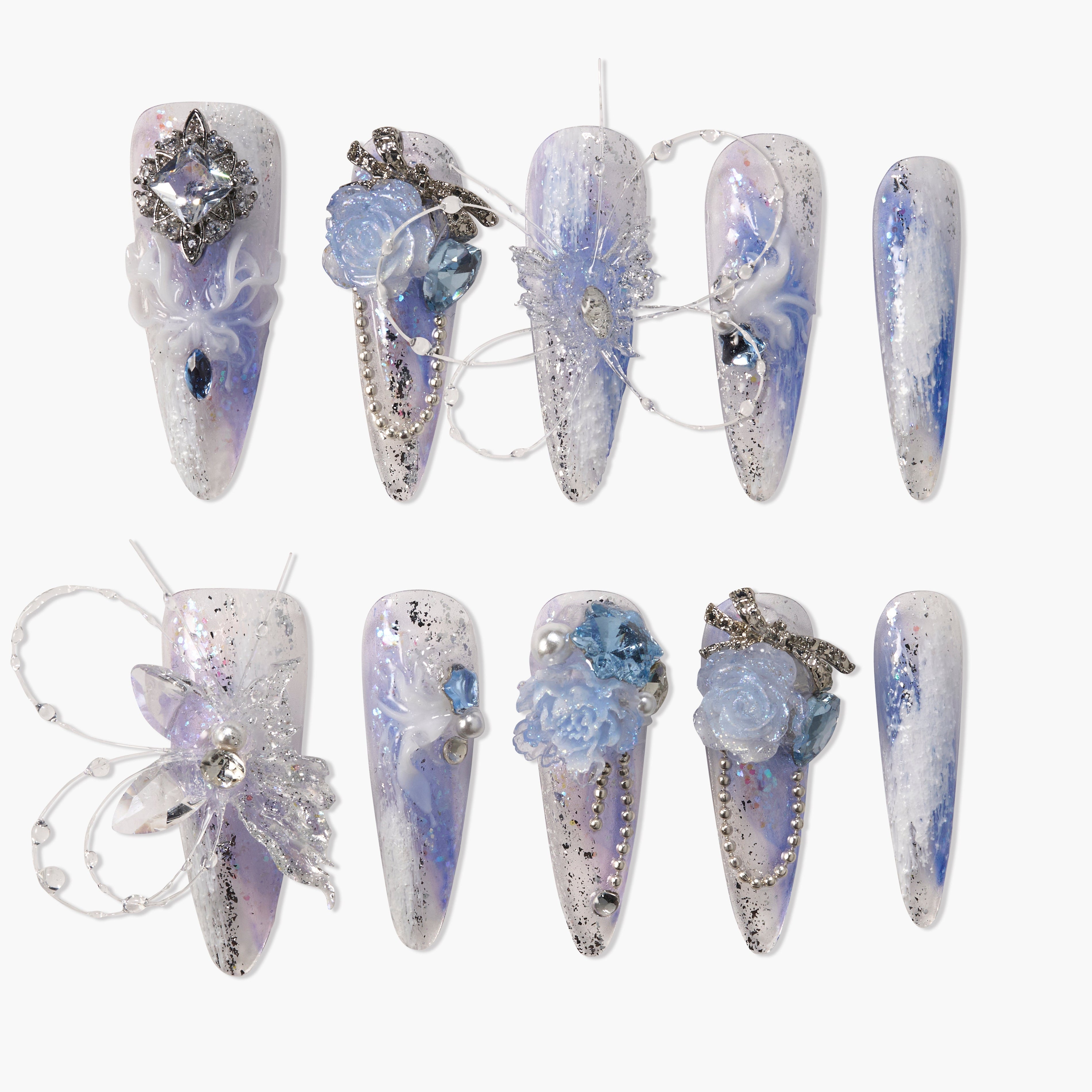 Long ombre blue and white press-on nails with silver glitter, 3D floral accents, and rhinestones