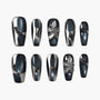 Black and silver press-on nails with 3D floral accents and metallic bead details, glossy finish