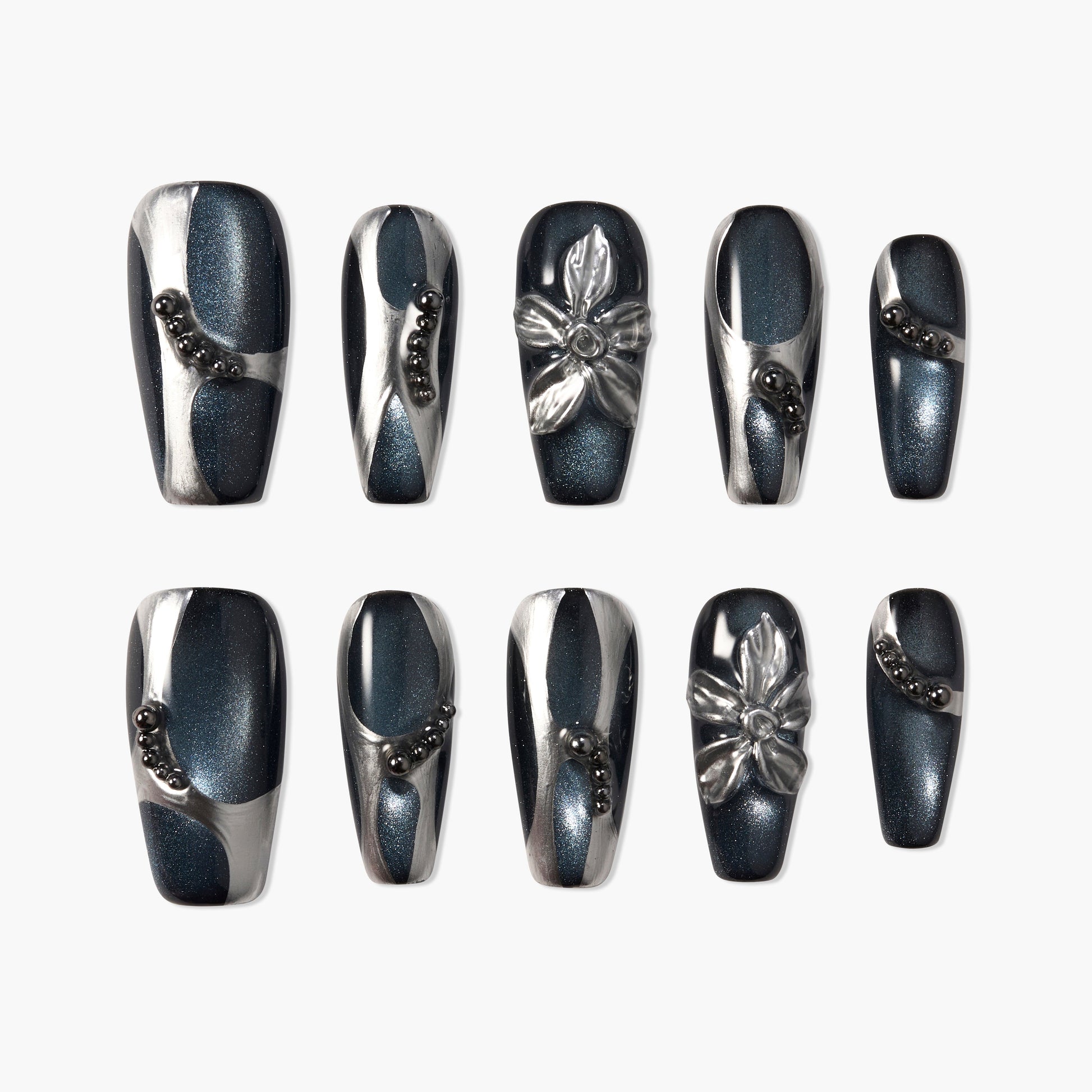 Black and silver press-on nails with 3D floral accents and metallic bead details, glossy finish