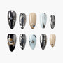 Handmade press-on nails set with metallic, beige, and light blue designs, featuring 3D gems and celestial accents.