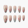 Handmade press-on nails with pink rose floral designs, pearls, and nude blue gradient tips