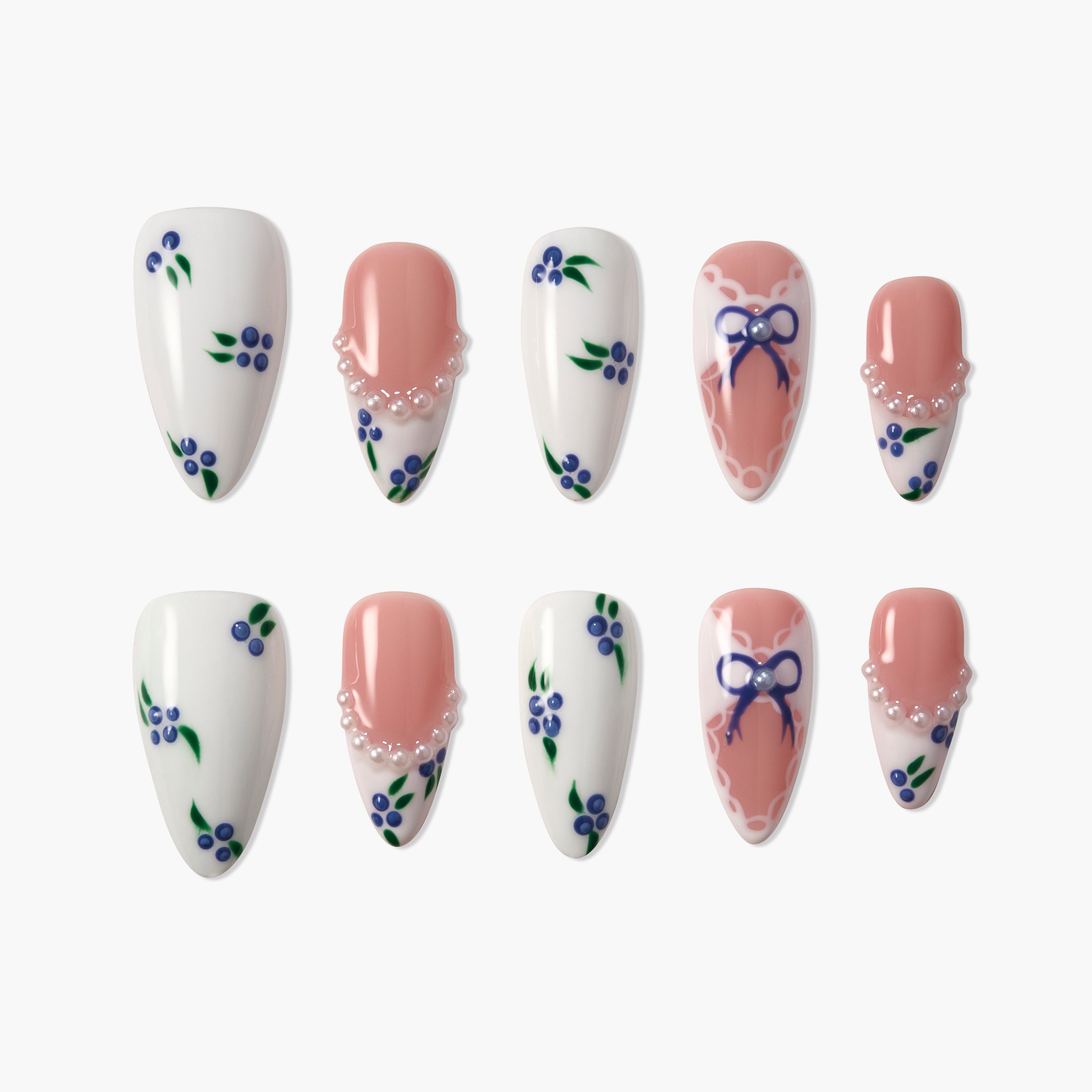 Handmade press-on nails with blue floral designs, pearls, and ribbon art on white and pink bases