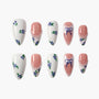 Handmade press-on nails with blue floral designs, pearls, and ribbon art on white and pink bases