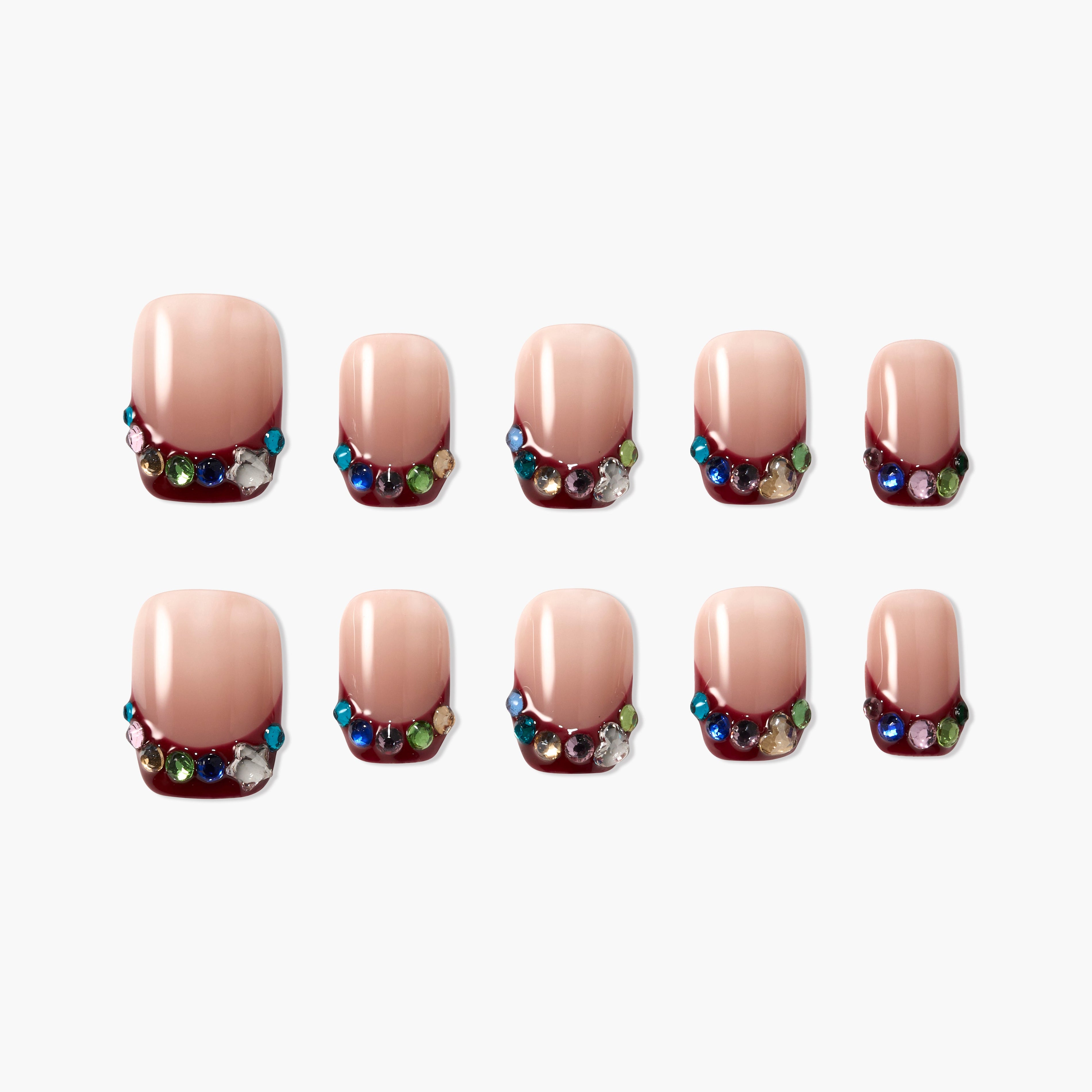 Handmade press-on nails with nude base, burgundy tips, and colorful rhinestone accents