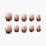 Handmade press-on nails with nude base, burgundy tips, and colorful rhinestone accents