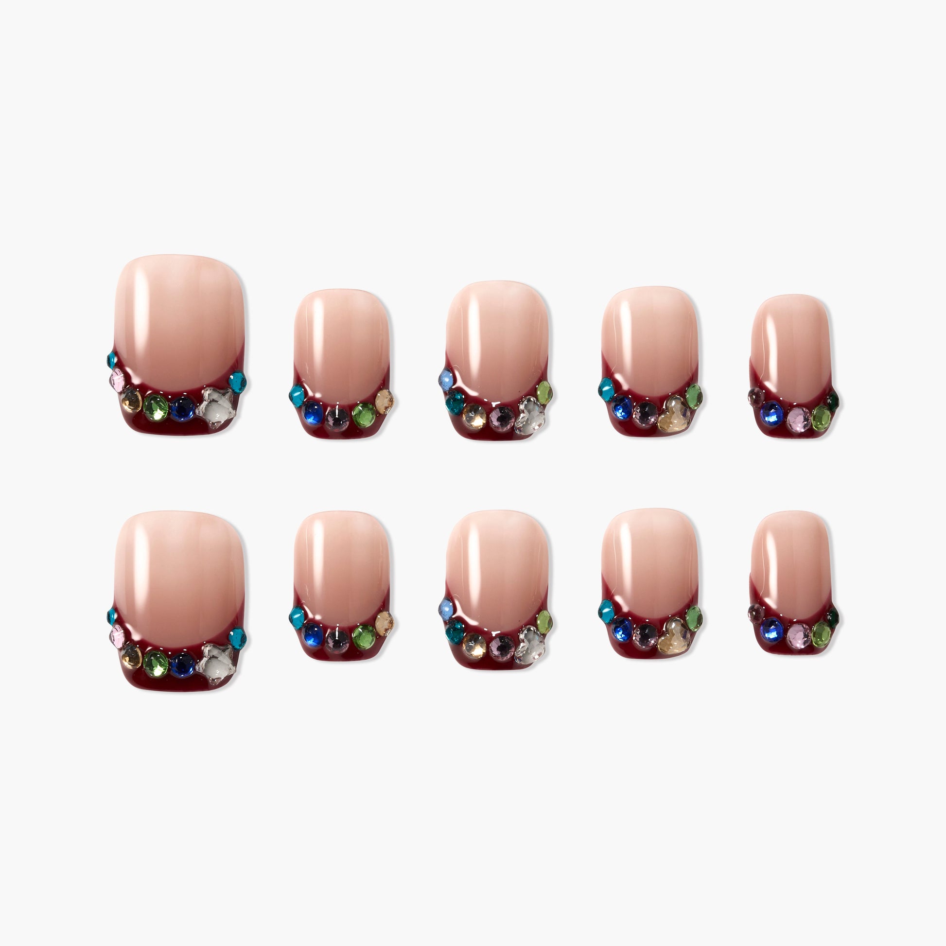 Handmade press-on nails with nude base, burgundy tips, and colorful rhinestone accents