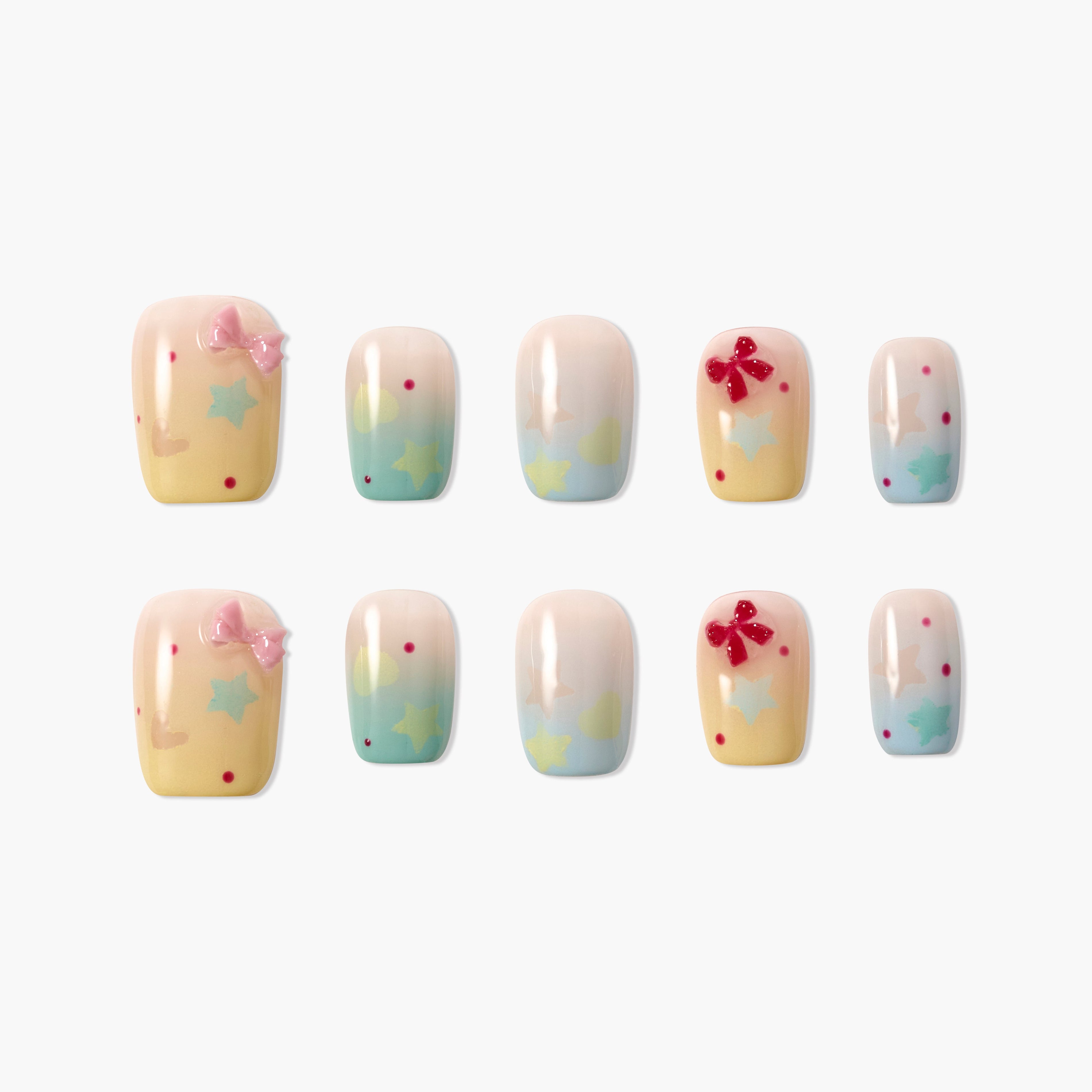 Handmade press-on nails with pastel bows, stars, and polka dots, glossy finish
