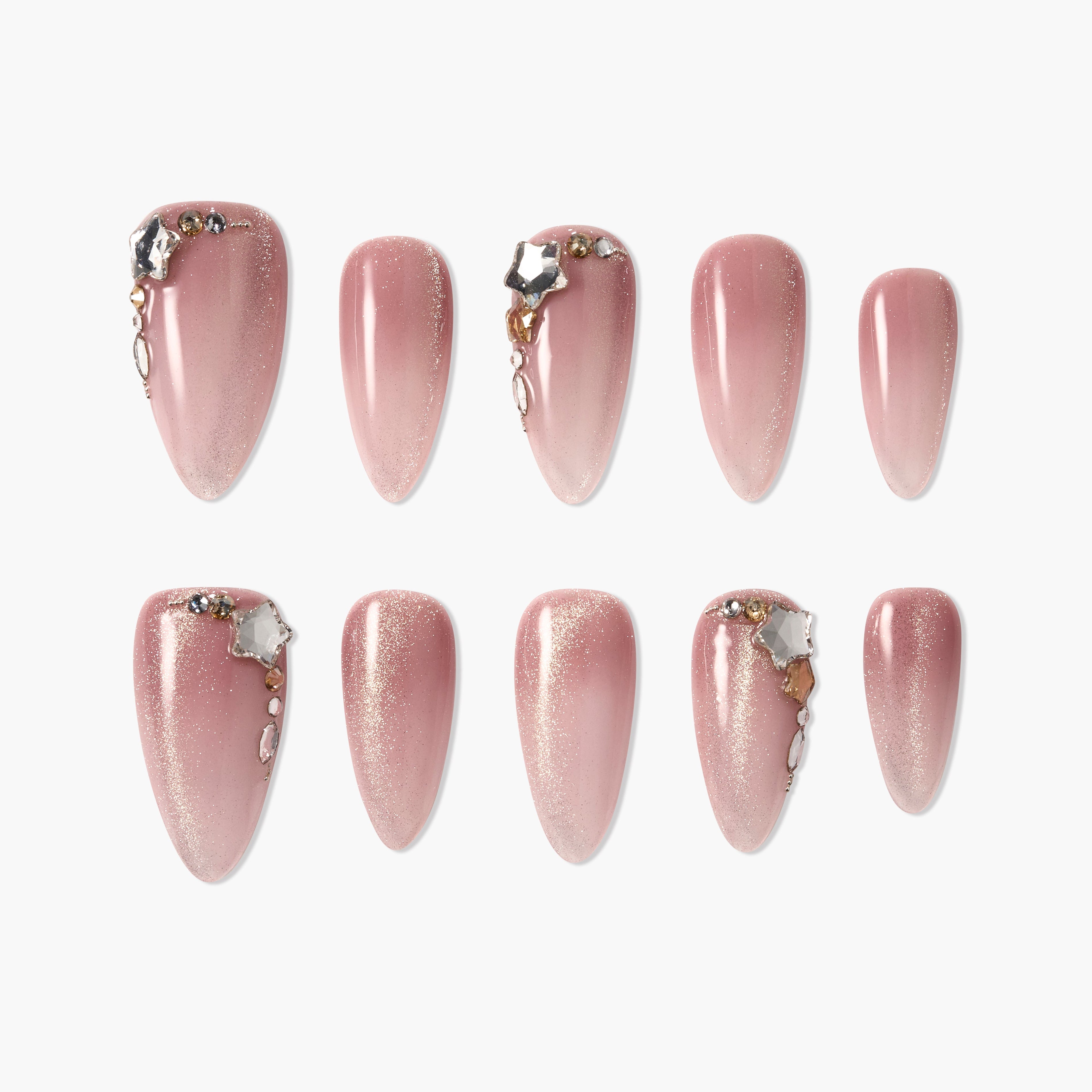 Set of pink glitter press-on nails with gold and jewel accents, arranged on white background