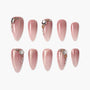 Set of pink glitter press-on nails with gold and jewel accents, arranged on white background