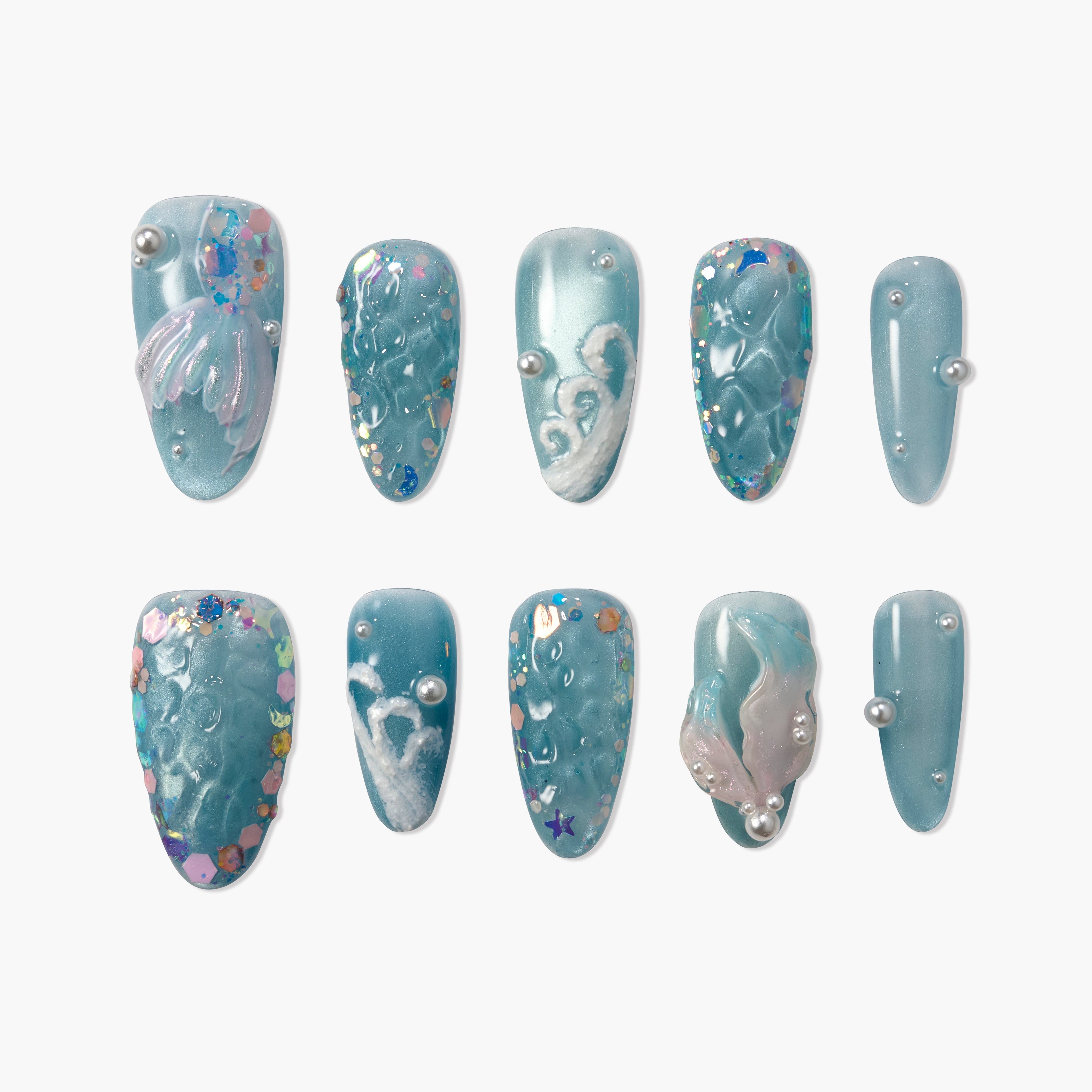 Blue press-on nails with pearl accents, glitter, and 3D ocean-inspired designs