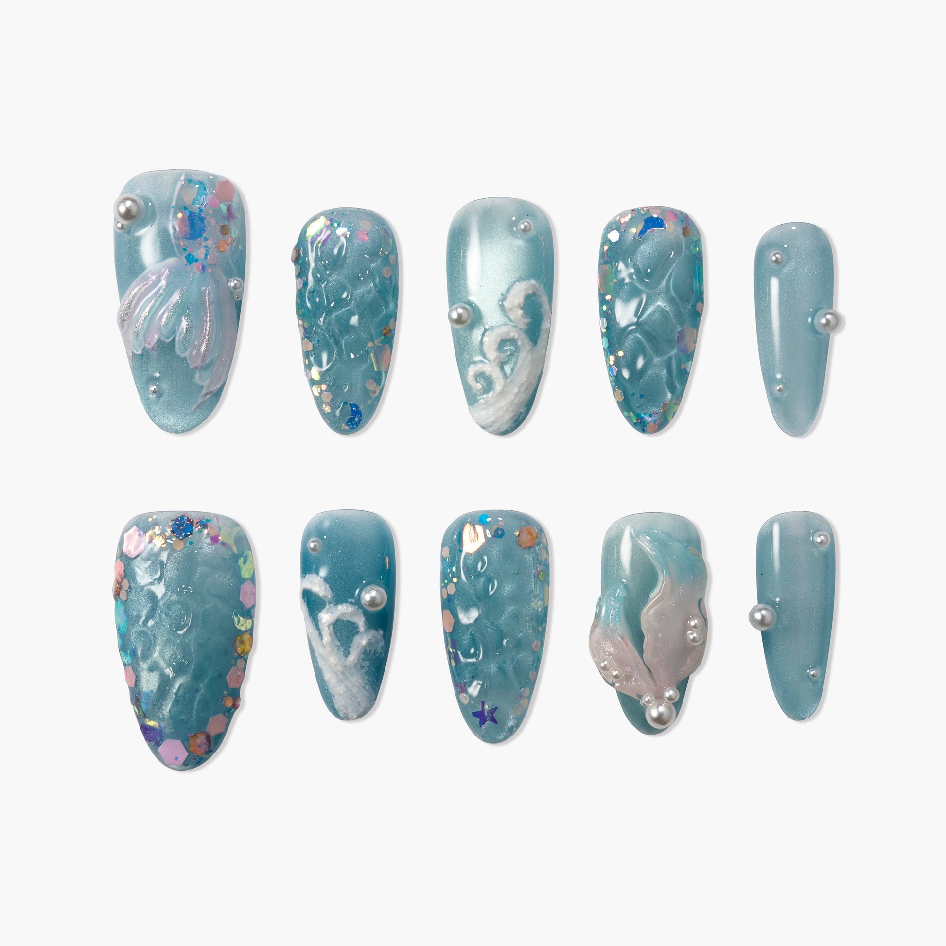 Blue press-on nails with pearl accents, glitter, and 3D ocean-inspired designs