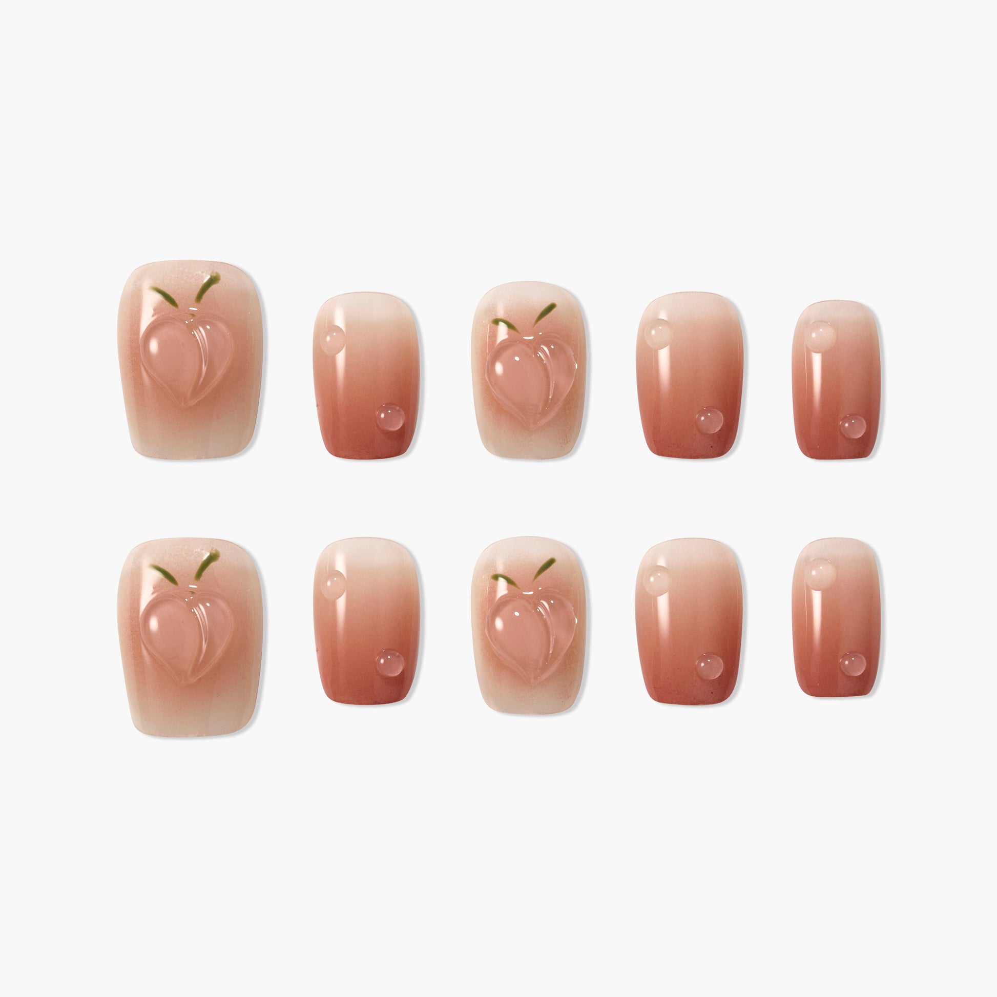 Peach design pink gradient press-on nails with glossy finish, arranged on white background