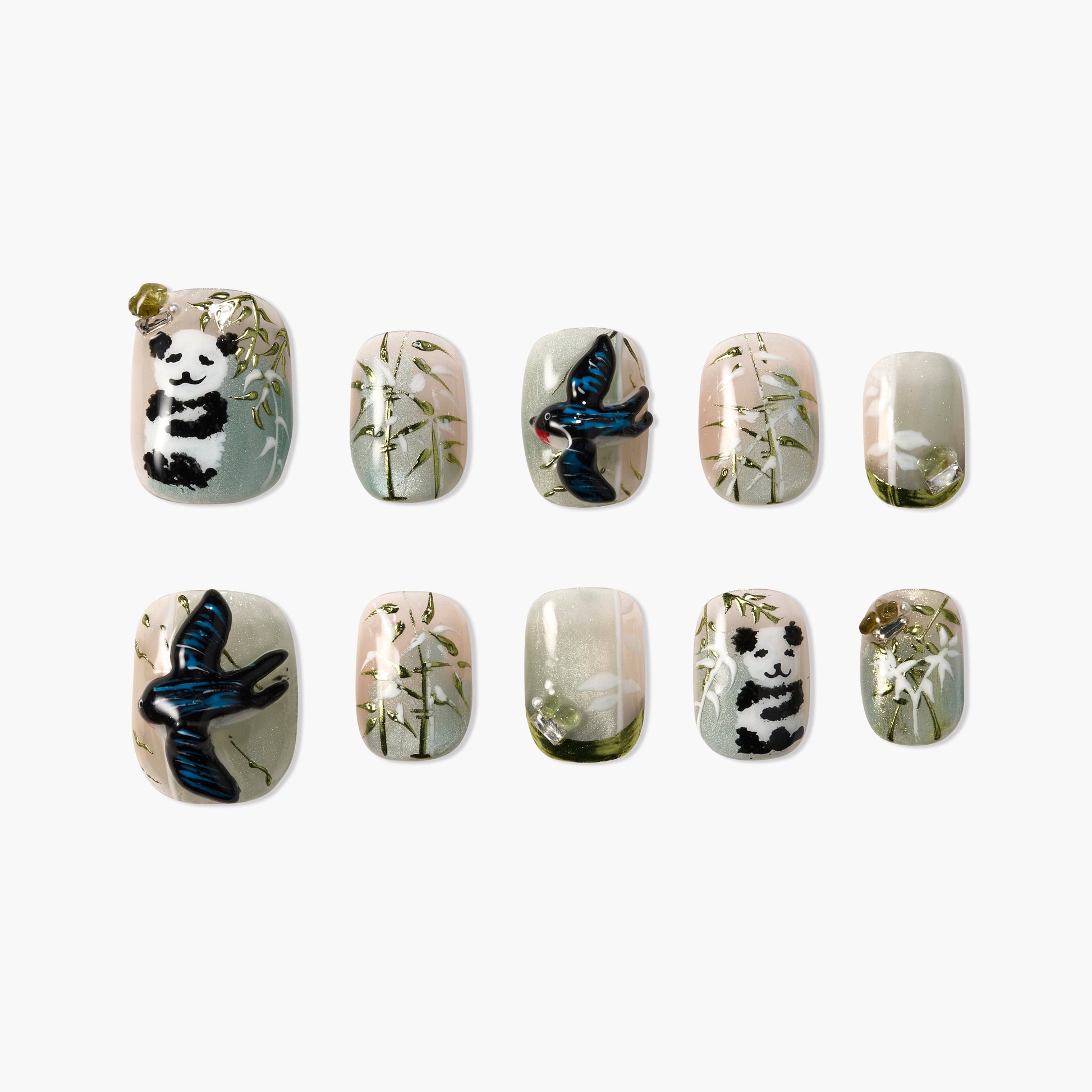 Handmade press-on nails with panda, blue bird, bamboo and nature-themed nail art design.