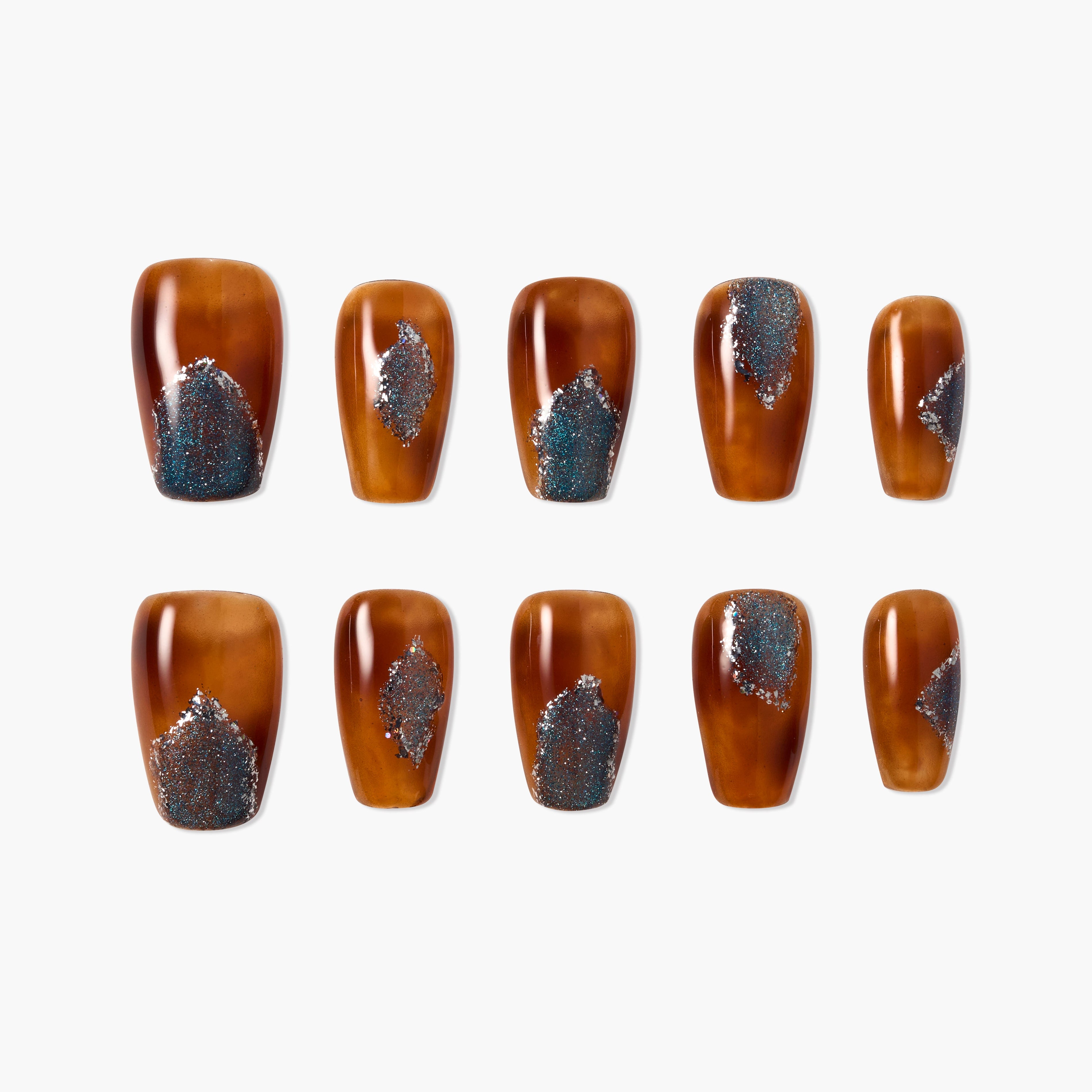 Set of brown press-on nails with blue and silver glitter design on a white background