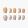 Handmade press-on nails with beige and white ombre base, pastel polka dot design