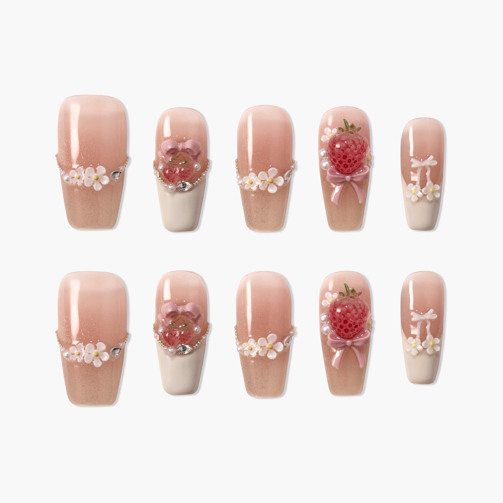 Handmade pink press-on nails with 3D strawberry, floral, pearl, and bow designs on white background