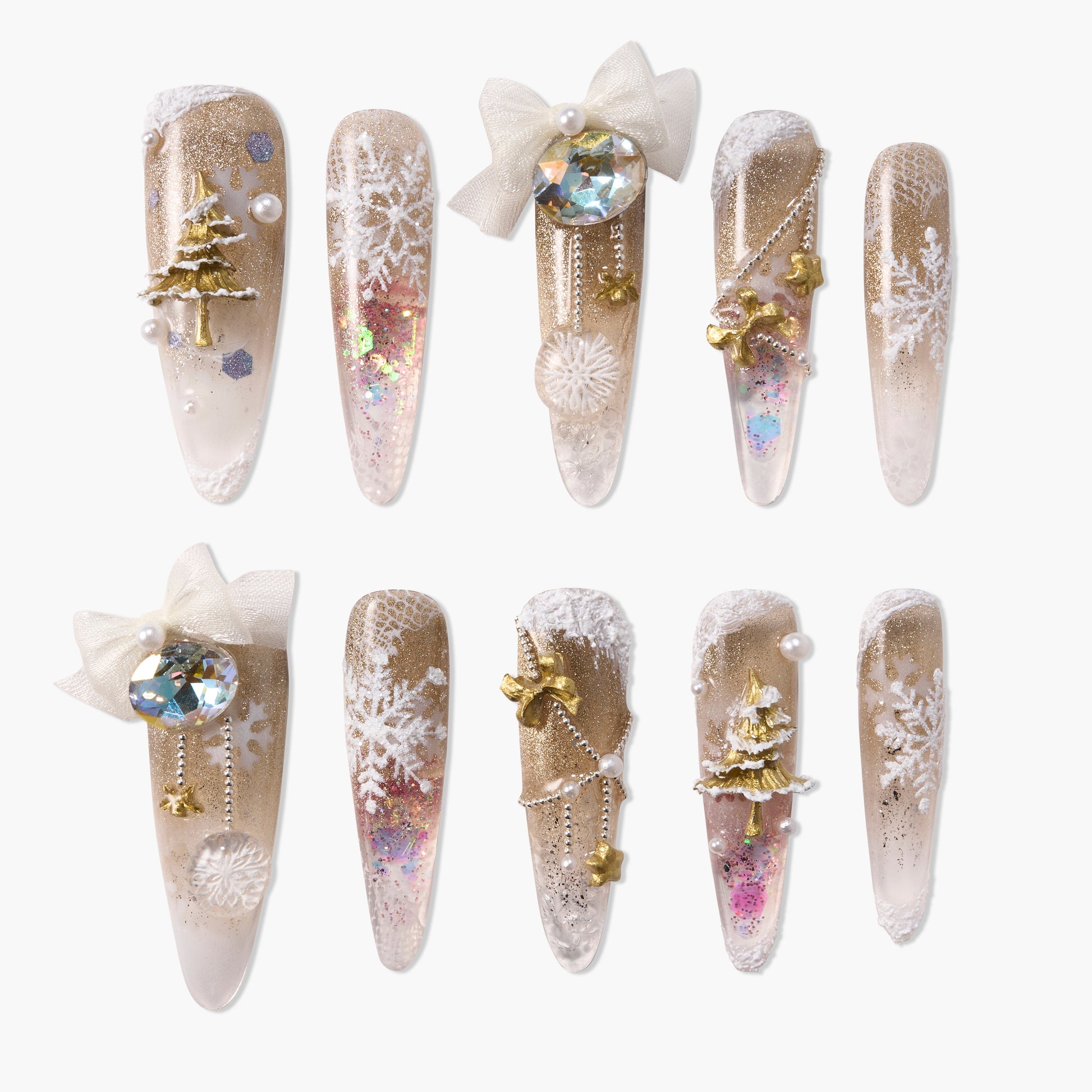 Gold and white winter press-on nails with snowflakes, glitter, bows, and 3D Christmas tree accents.