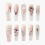Handmade press-on nails with glitter, pink floral designs, and 3D gemstone accents