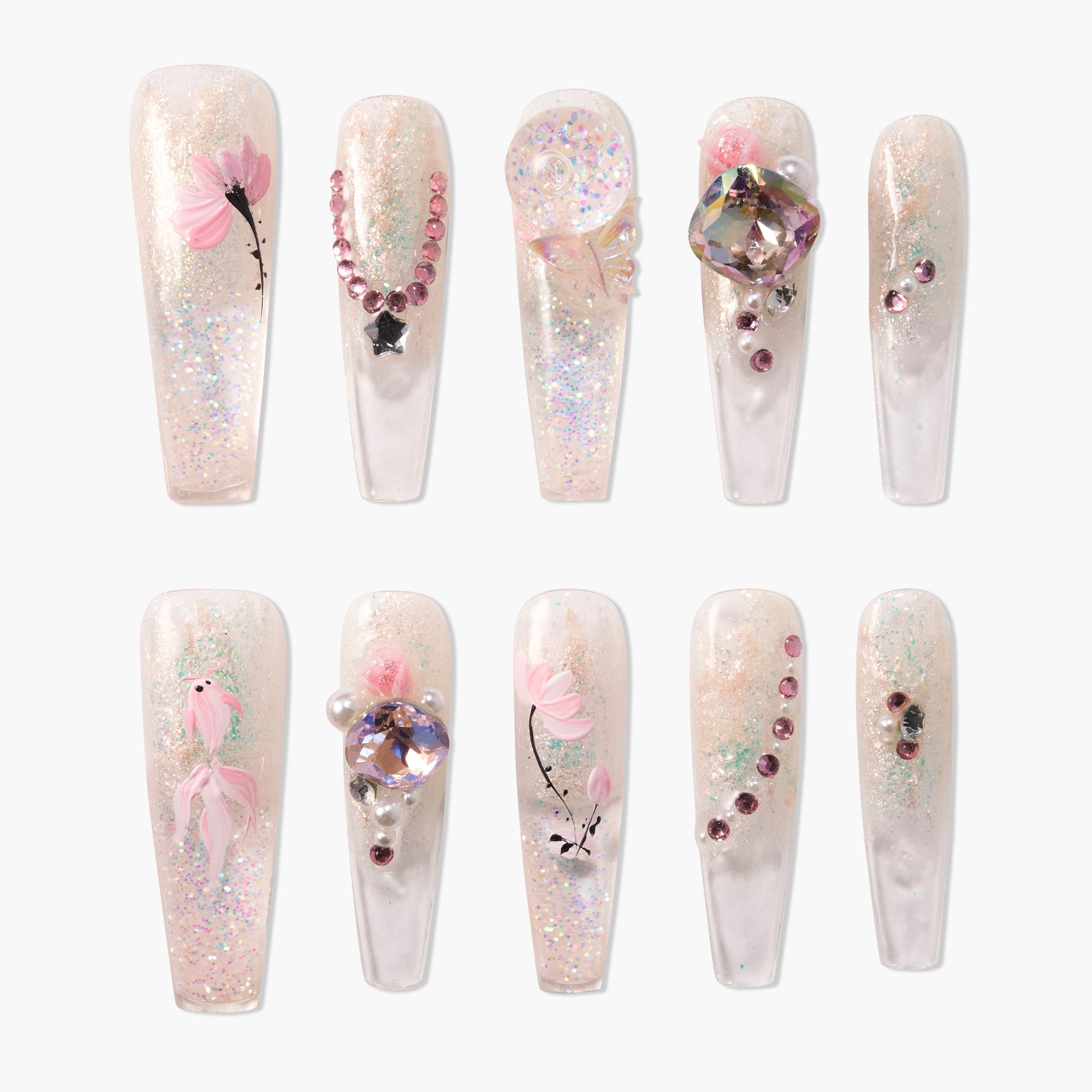Handmade press-on nails with glitter, pink floral designs, and 3D gemstone accents