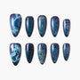 Blue glitter press-on nails with mermaid and ocean-themed designs, handmade, reusable.
