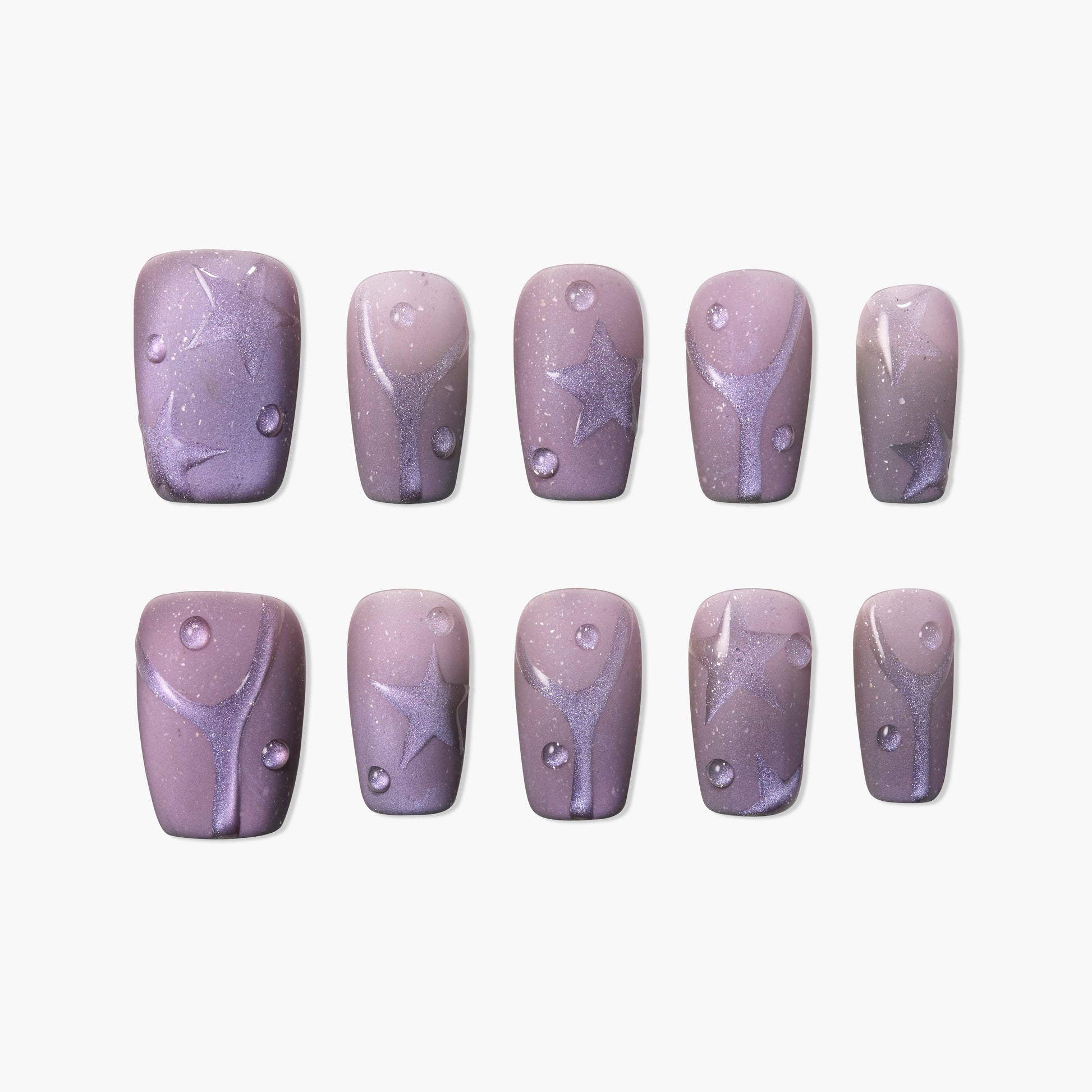 Handmade press-on nails with glittery purple star and swirl designs on mauve background