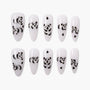 Handmade press-on nails with white base and cute black panda bear designs, set of ten.