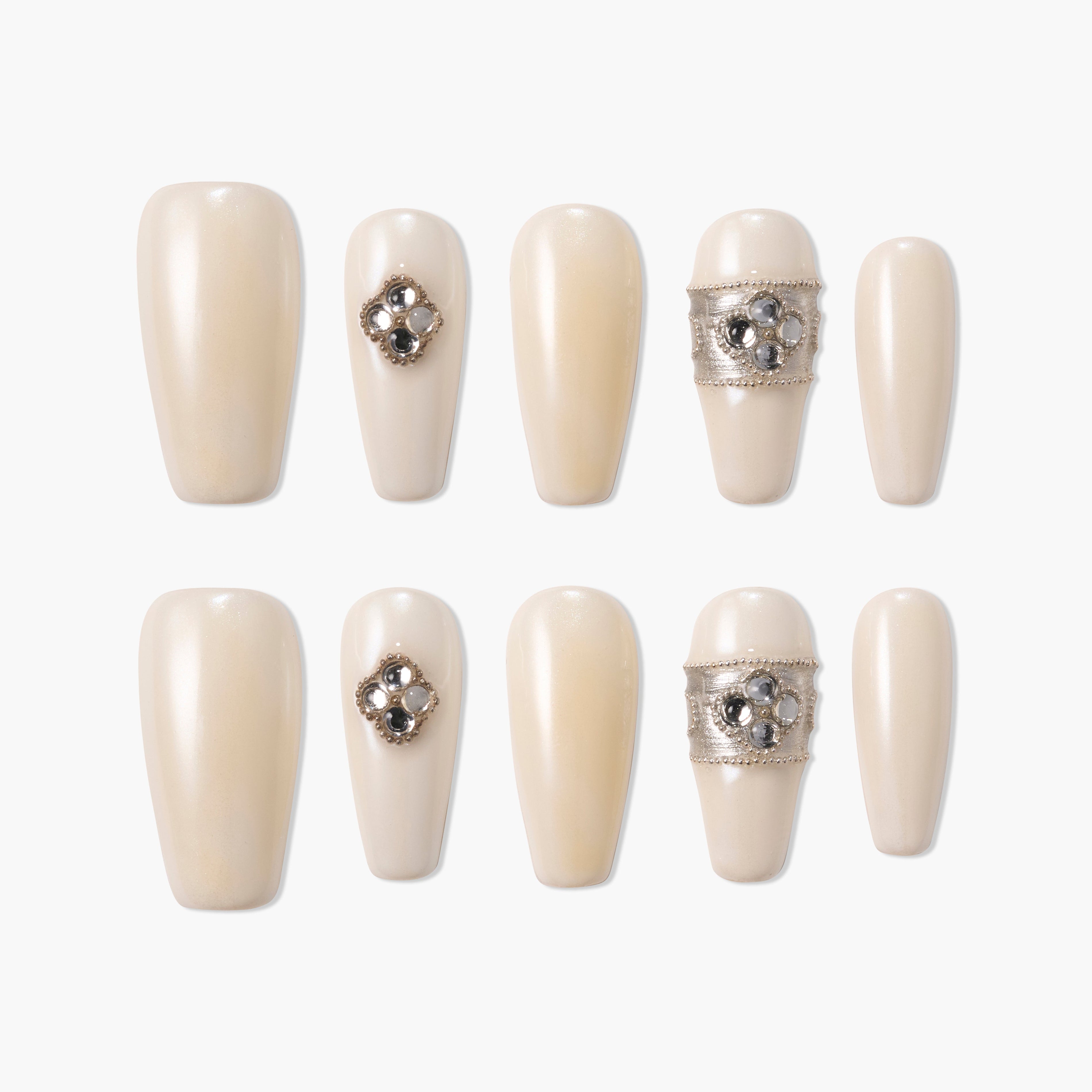 Pearl white press-on nails with jeweled accents and silver decorative bands, set of ten.