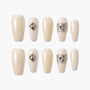 Pearl white press-on nails with jeweled accents and silver decorative bands, set of ten.